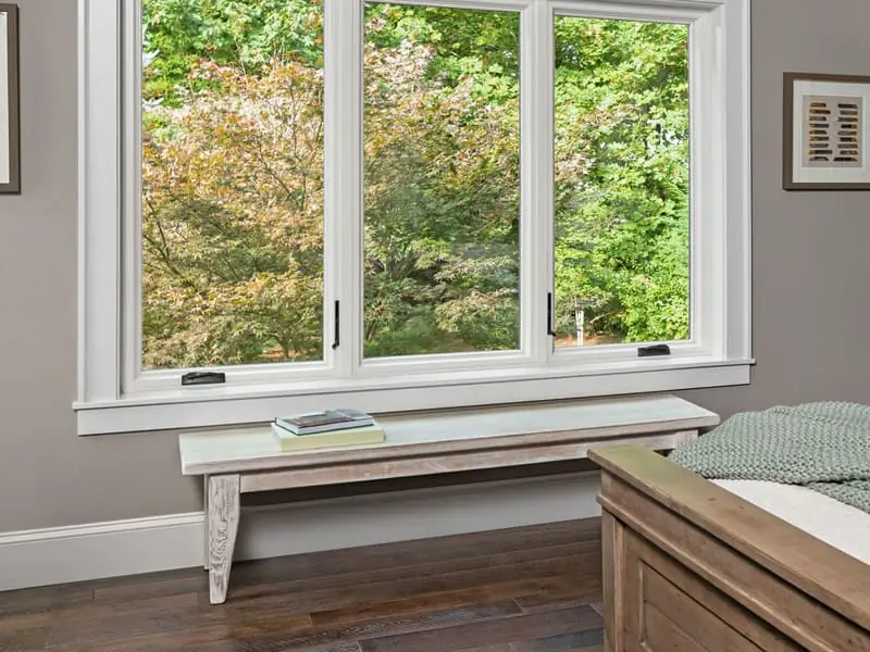 Living room with black-frame replacement windows — the kind of work local partners deliver in Nanticoke